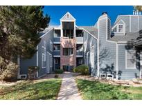 Gray condo building with brick accents and a walkway at 11109 Alcott St # D, Westminster, CO 80234