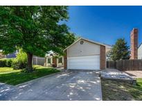 Charming home featuring a well-manicured front lawn and a two-car garage at 1572 W Long Ave, Littleton, CO 80120