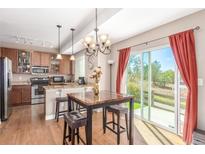 Eat-in kitchen with granite countertops, stainless steel appliances, and sliding glass door to the backyard at 12921 Grant W Cir # B, Thornton, CO 80241
