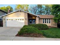Inviting single-Gathering home features a two-car garage and beautiful landscaping, creating a welcoming curb appeal at 8908 Jellison Ct, Westminster, CO 80021