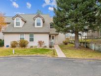Charming home exterior featuring dormer windows, manicured lawn, and mature landscaping at 2182 S Victor St # D, Aurora, CO 80014