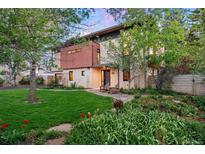 Striking modern home with lush landscaping and a welcoming front yard with beautiful lawn and garden areas at 3665 Estes St, Wheat Ridge, CO 80033