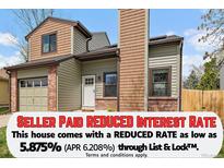 Charming two-story home featuring mixed siding, brick accents, and attached garage at 5773 W 76Th Dr, Arvada, CO 80003