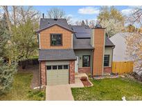 Charming two-story home featuring brick accents, solar panels, and a well-maintained front yard at 5773 W 76Th Dr, Arvada, CO 80003