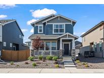 Charming two-story home with a landscaped front yard and inviting front porch at 730 Cottonwood Ave, Bennett, CO 80102