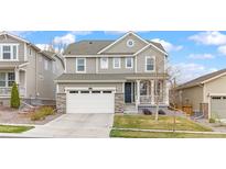Charming two-story home with a well-manicured lawn and a two-car garage, perfect for suburban living at 16108 Red Bud Loop, Parker, CO 80134