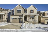 Two-story house with light beige siding, gray accents, and a large front yard at 5553 Wisteria Ave, Firestone, CO 80504