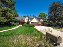 Charming two-story home with well-maintained landscaping and a spacious driveway at 15395 E Penwood Pl, Aurora, CO 80015