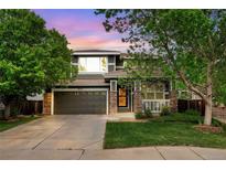Charming two-story home featuring a two-car garage, covered porch, and well-maintained lawn at 9272 Melborne Ct, Parker, CO 80134