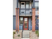 Charming townhouse front door with brick pillars and small upper balcony with view of house number at 9490 W 14Th Ave # 3, Lakewood, CO 80215