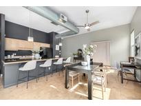 Open-concept kitchen with bar seating, modern appliances, and sleek design at 2501 15Th St # 2C, Denver, CO 80211