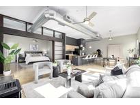 Bright, open floor plan with modern decor, kitchen island, and visible bedroom enhance this inviting living space at 2501 15Th St # 2C, Denver, CO 80211