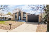 Charming two-story home with a well-manicured lawn and attached two car garage at 3134 S Fairplay St, Aurora, CO 80014