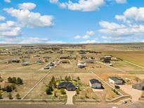 Expansive aerial view of a large home and property showcasing the surrounding landscape and neighborhood at 56330 E 37Th Ct, Strasburg, CO 80136