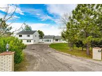 Inviting home with a well-maintained yard, charming brick mailbox, and a long driveway leading to ample parking at 43388 Somerset Ct, Elizabeth, CO 80107