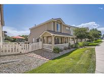 Two-story home featuring a cozy front porch and manicured lawn, perfect for suburban living at 11832 Zenobia Loop, Westminster, CO 80031