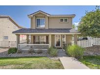 Charming two-story home with a covered front porch, landscaped yard, and a welcoming entrance at 11832 Zenobia Loop, Westminster, CO 80031