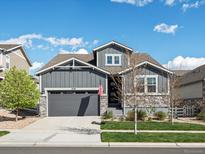 Charming two-story home featuring stone accents, a gray color scheme, and a well-manicured lawn at 27110 E Fremont Pl, Aurora, CO 80016