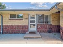 Brick facade with a front door and large windows offering plenty of natural light at 4233 Shoshone St, Denver, CO 80211