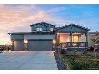 Beautiful two-story home featuring a two-car garage and inviting covered porch at 1845 Meagan Way, Erie, CO 80516