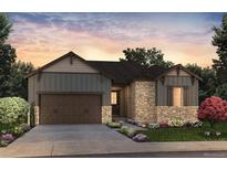 Charming single-Gathering home featuring stone accents, a two-car garage, and a beautifully landscaped front yard at 8555 Hotchkiss St, Littleton, CO 80125