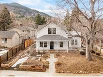 Charming two-story home features a welcoming front porch and beautiful mountain views at 1327 6Th St, Boulder, CO 80302