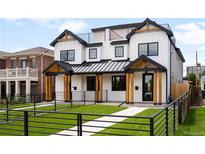 Modern two-story home with white siding, black trim, manicured lawn, and a black metal fence at 1571 Vrain St, Denver, CO 80204