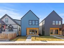 Modern two-story home featuring complementary exterior colors and manicured front yard at 3725 N Franklin St, Denver, CO 80205