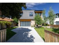 Contemporary two-story home with a concrete driveway and a glass paneled garage door, complemented by landscaping at 3485 S Clermont St, Denver, CO 80222