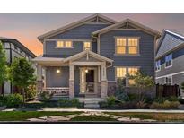 Charming two-story home with landscaped front yard, inviting porch, stone accents, and professionally maintained lawn at 5439 Verbena St, Denver, CO 80238