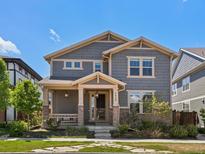 Charming two-story home with well-maintained lawn, stone accents, covered porch, and inviting curb appeal at 5439 Verbena St, Denver, CO 80238