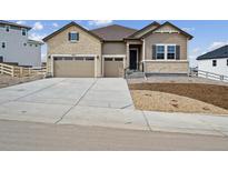 Charming single-Gathering home showcasing a two-car garage and neutral-toned stone and siding details at 4975 Hickory Oaks St, Castle Rock, CO 80104