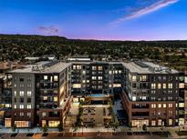 Stunning multi-story condominium building with mountain views at sunset and lush landscaping at 20 Wilcox St # 309, Castle Rock, CO 80104