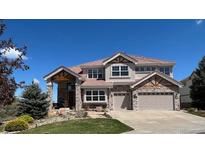 Beautiful two-story home featuring a well-manicured lawn and an attached two car garage at 23965 E Kettle Pl, Aurora, CO 80016