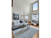 Inviting living room with a high ceiling, plush seating, and a calming Buddha art piece, creating a serene space at 5161 S Emporia Way, Greenwood Village, CO 80111