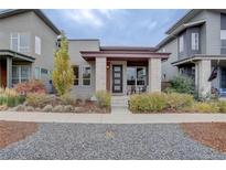 Charming home featuring a modern design, well-maintained landscaping, and a welcoming front porch at 10630 E 26Th Ave, Aurora, CO 80010