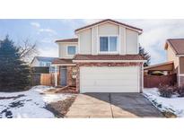 Two-story house with attached garage and landscaping at 4105 Malta St, Denver, CO 80249