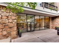 Modern building entrance featuring glass doors, stone accents, and clear signage for easy access at 1020 15Th St # 20F, Denver, CO 80202