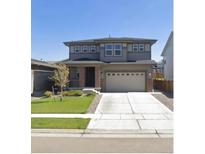 Charming two-story home features a two-car garage, landscaped front yard, and welcoming front porch at 1846 Osprey Dr, Brighton, CO 80601