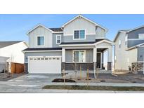 Two-story house with gray siding, white trim, and a two-car garage at 1322 Bloom St, Brighton, CO 80601