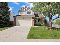 Charming two-story home featuring a well-maintained lawn, a two-car garage, and a welcoming front porch at 20293 E Progress Pl, Centennial, CO 80015