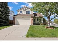 Charming two-story home with a well-maintained front yard and attached two-car garage at 20293 E Progress Pl, Centennial, CO 80015
