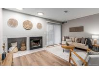 Inviting living room features a fireplace and decorative wall art, offering a cozy and stylish ambiance at 2575 S Syracuse Way # B101, Denver, CO 80231