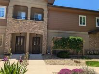 Attractive townhouse featuring stone accents, private balconies, and well-maintained landscaping at 1122 Olympia Ave # 12H, Longmont, CO 80504
