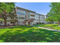 Well-maintained condo building with landscaped lawn and mature trees at 750 S Alton Way # 8C, Denver, CO 80247