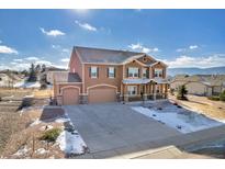 Two-story house with a large driveway and attached garage,mountain views at 1235 Woodmoor Acres Dr, Monument, CO 80132