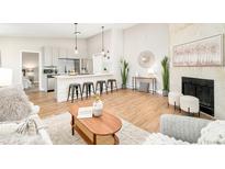 Open living room with fireplace and modern decor at 7122 S Bryant St # 136, Littleton, CO 80120