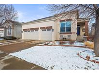 Charming stucco home featuring a spacious two-car garage and a welcoming front entrance at 6700 W Dorado Dr # 51, Littleton, CO 80123