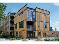 Modern multi-story home features natural wood and dark gray siding with complementary black trim at 1601 Park Ave # 106, Denver, CO 80218