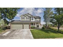Two-story house with attached garage and landscaped yard at 1517 Stanley Dr, Erie, CO 80516